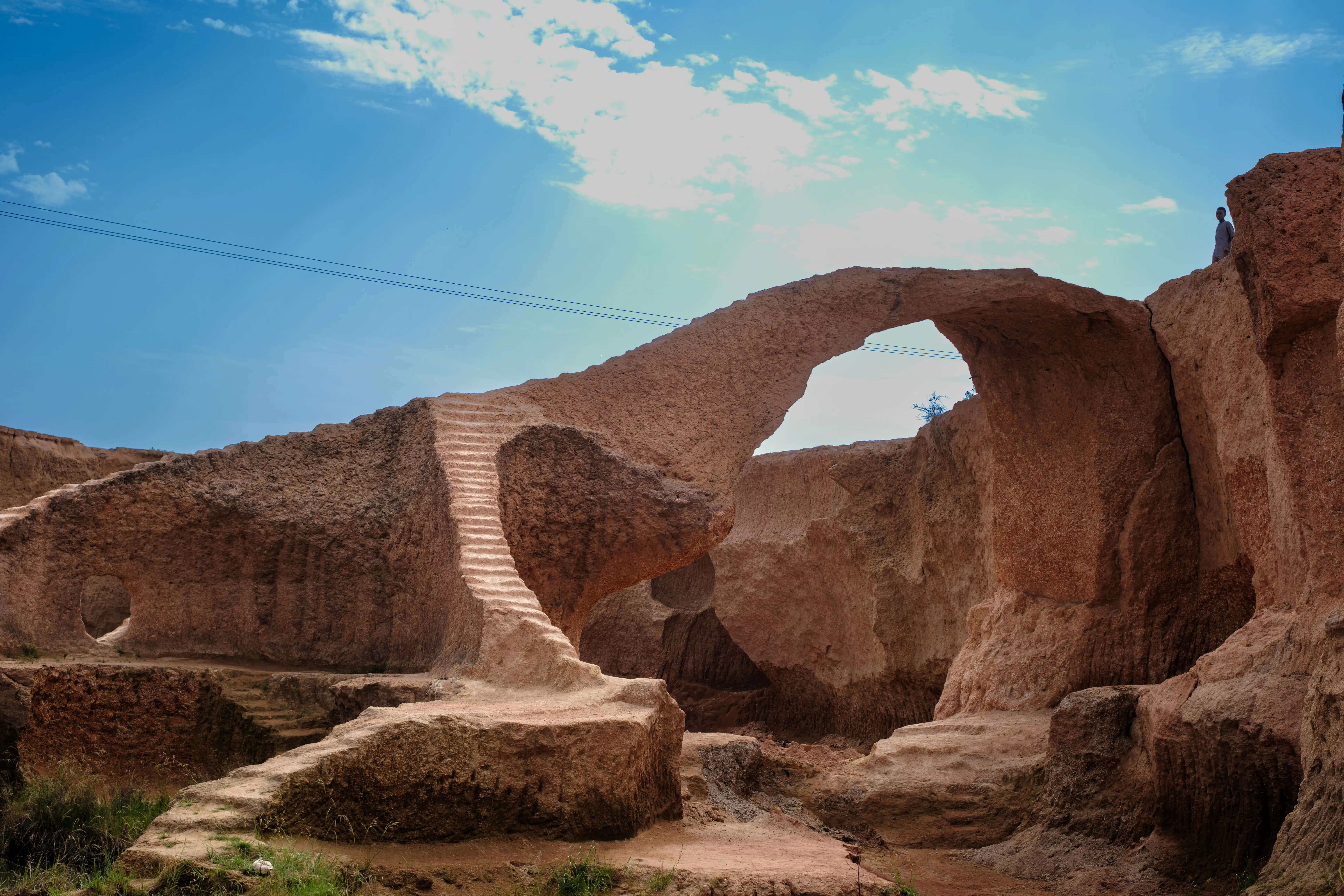 Portrait of an artisan resting beside stacked bricks