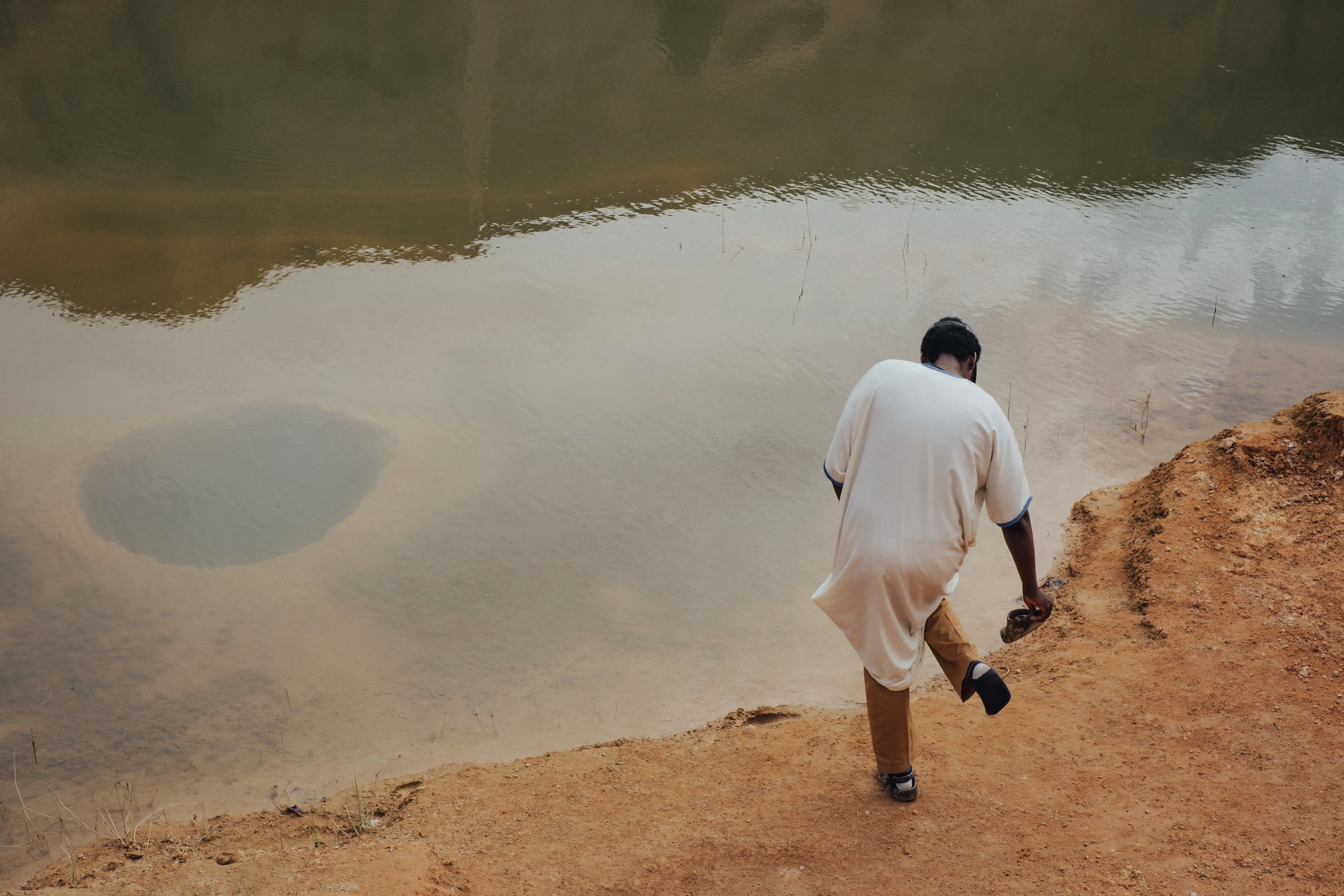 Artisan lifting a brick from the mold