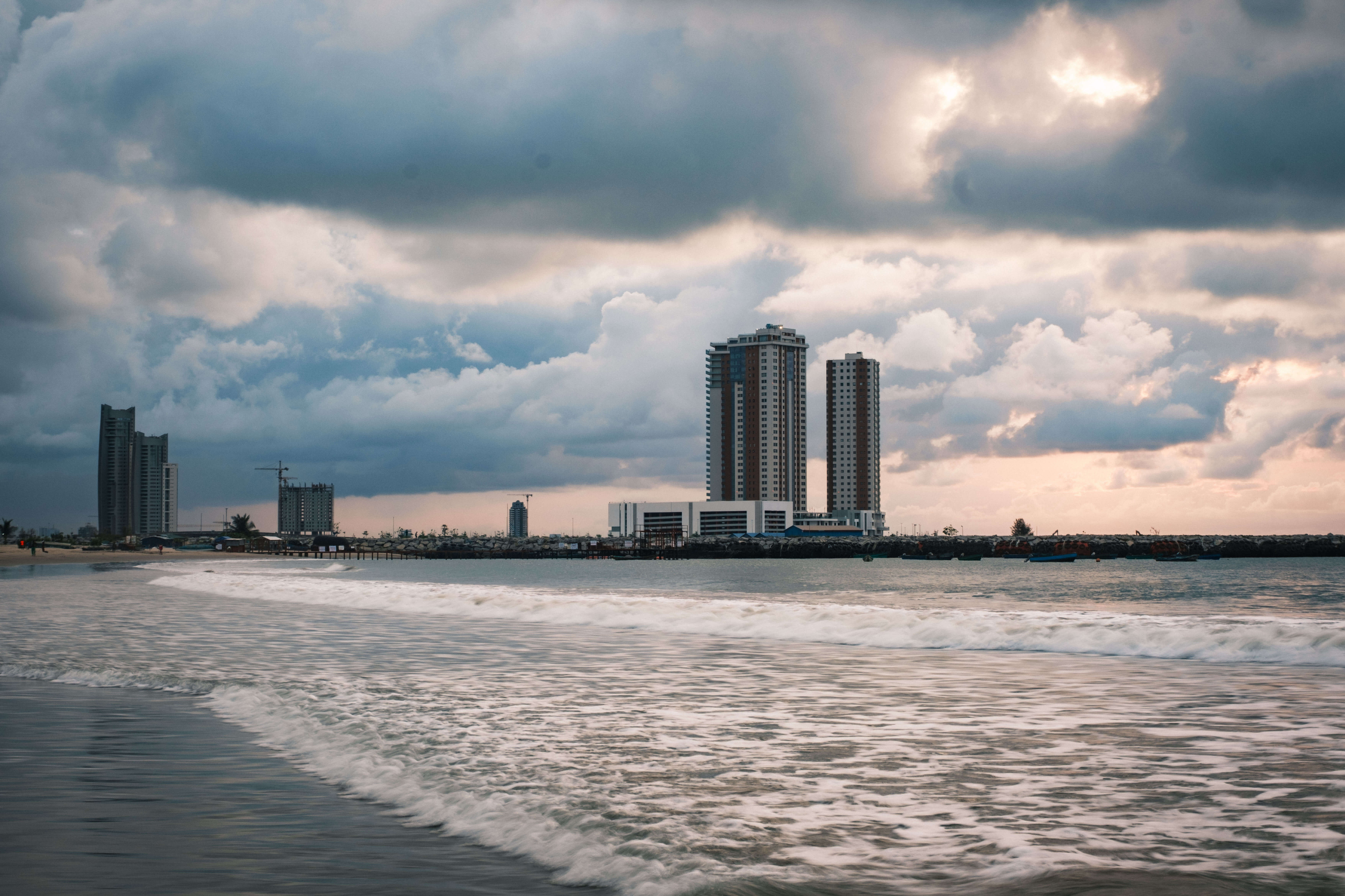 Portrait of a Tarkwa Beach vendor framed by breaking waves