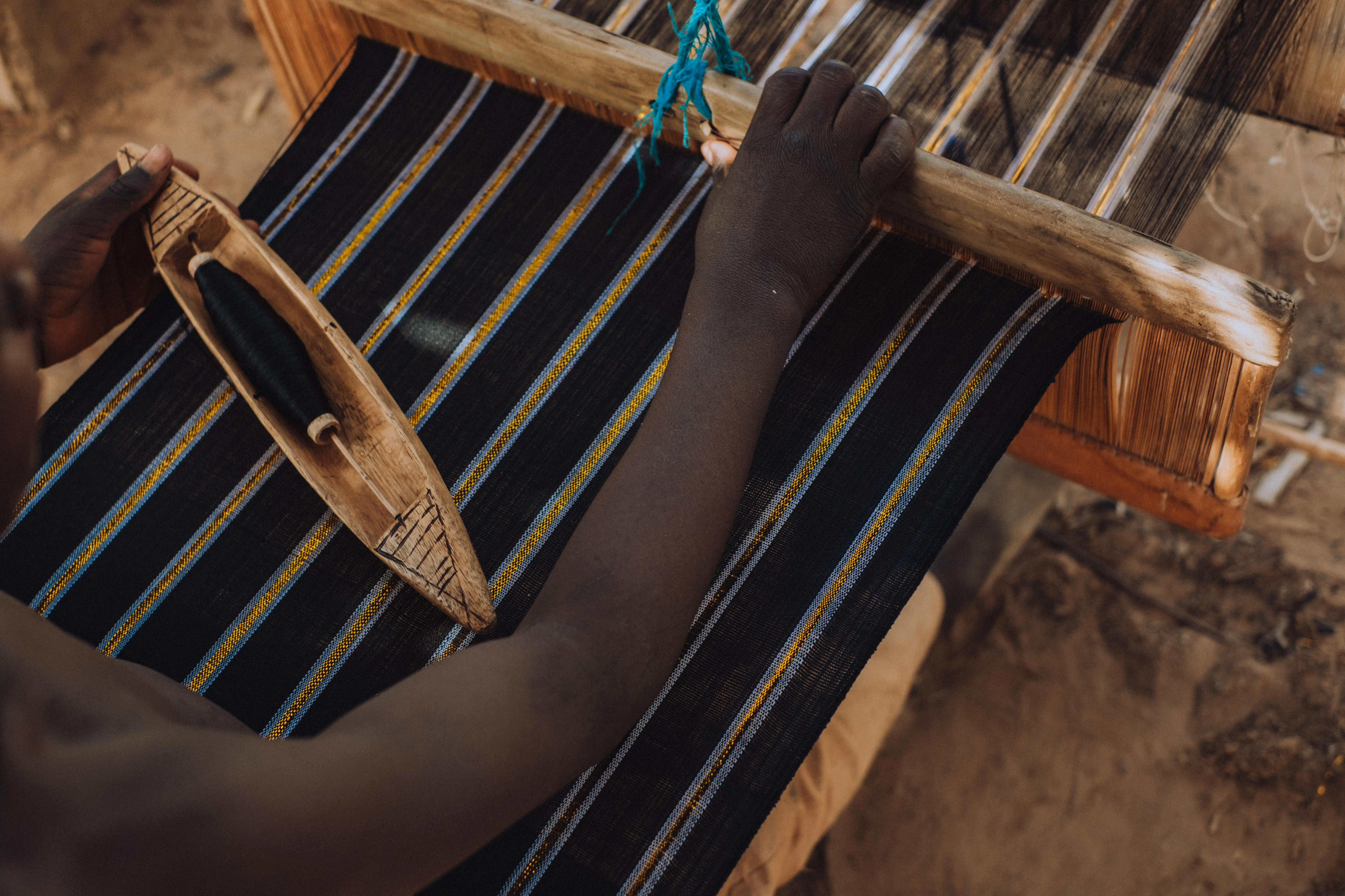 Evening portrait beside finished Kano textiles